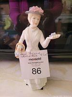 Full view of Royal Stafford Shire figurine named 'Eliza' showing the front of the figurine with the woman holding flowers and a basket.