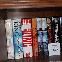 Photo showing a row of 8 hardcover Stephen King books including titles Full Dark, No Stars, Dreamcatcher, Misery, Just After Sunset, Dolores Claiborne, The Tommyknockers