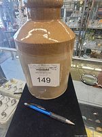 Photo of the brown vintage jug showing front view and seller label.