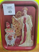 Full view of vintage red Coca-Cola metal tray with Victorian era woman and ornate decorative table
