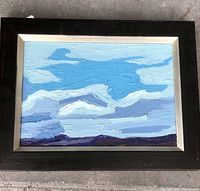 Front view of framed oil painting showing full composition of clouds, sky and horizon.