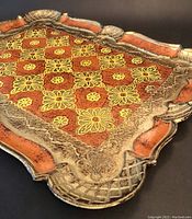 Close-up of the ornate floral design and composite border of the tray.