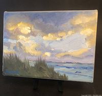 Front view of the 5x7 inch oil painting showing a cloudy sky over ocean with grassy foreground and signature.