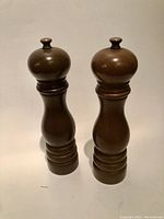 Front view of both wooden grinders showing overall shape and size.