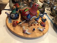 Top view of the wooden bird figurines and decorative mushrooms arranged on a wooden base.