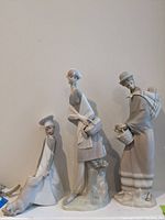 Front view of all three figurines displayed on shelf