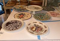 Group view showing five serving plates arranged around a white ceramic cake pedestal.