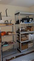 Two plastic storage shelves shown from front, filled with various items but contents not included.