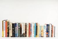Wide view of all 37 military history books arranged side by side showing titles and condition.