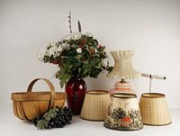 Full lot view showing wooden basket with vintage plastic fruit, bouquet of plastic flowers in red vase, and four small lamp shades.