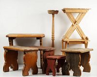 Eight varied wooden plant stands arranged together showing different sizes, shapes, and wood finishes.