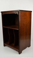 Left three-quarter view showing open front with top shelf and bottom divided storage