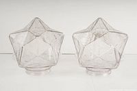 Front view of the pair of transparent textured star-shaped glass lamp shades displayed side by side.