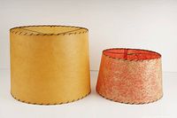 Side view showing both fiberglass lamp shades, yellow larger shade and smaller orange swirled shade.