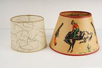 Photo of both lamp shades side by side on white background, one cylindrical with abstract pattern, one conical with cowboy western print.