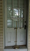 Full view of the vintage bird cage stand showing entire height, circular top ring, and weighted base.