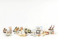 Wide view of the vintage miscellaneous decorative small items lot showing all pieces spread out on a white surface.