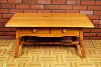 Front view of vintage VILAS wooden coffee table showing two drawers and turned legs.