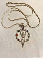 Sterling silver necklace with seven chakra goddess pendant showing stones and goddess figure.