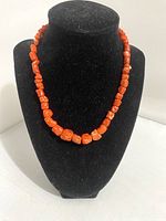 Necklace displayed on black velvet necklace stand, showing general look and bead shape.