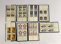 Front view of eight blocks of US postage stamps showing various historical and cultural themes.