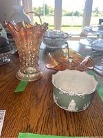 Photo showing all three items together on a wooden surface with sunlight coming through a window behind