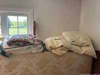 Double duvet with bed skirt and pillowcases on a floral couch, showing folded linens including the duvet cover and bed skirt.