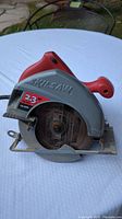 Front view of the Skilsaw circular saw showing 2.3 HP and 12 AMP label on gray guard and red body.