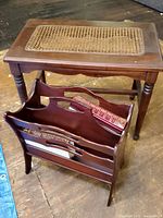 Overview showing the wooden bench with caned seat, the wooden magazine rack holding three Reader's Digest books.