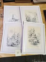 Four Jas F. Murray pencil drawing prints of Boston landmarks, matted and framed in white, arranged on a table.