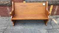 Front view of the oak church pew bench showing straight backrest and solid seat