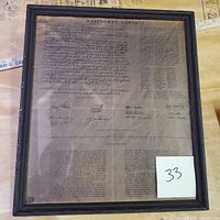 Front view of the framed Mayflower Compact reproduction showing the aged parchment, signatures, and explanatory notes.