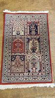 Full view of the Persian scatter rug showing its rectangular shape, colors, and border with fringes.