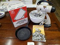 Sunbeam Mixmaster, Wagner skillet, Henckels knife block box and manual on wooden table