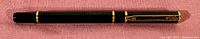 Side view of capped Waterman Laureat ballpoint pen showing black finish and gold-plated clip and trim.