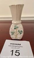 Front view of small Belleek vase showing basket weave pattern and hand-painted shamrocks, fluted top visible