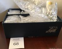 Black box containing 6 bubble wrapped crystal glasses, partially visible.