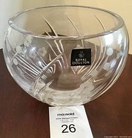 View of the Royal Doulton crystal bowl showing the clear surface, etched floral and line pattern, and brand label on the front.