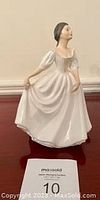 Front view of Royal Doulton Donna figurine in white dress with puffed sleeves