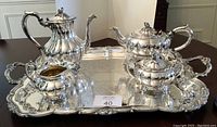 Full view of tea service set on tray showing coffee pot, teapot, sugar bowl, creamer, waste bowl