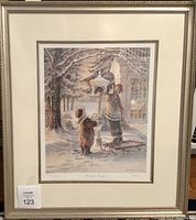 Framed watercolor print showing two children feeding birds on a snowy day, with sled and winter scenery.