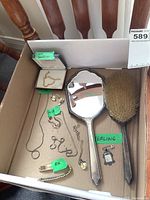 Box with sterling silver hand mirror, sterling hairbrush with natural bristles, multiple silver and gold necklaces, earrings, charm, and bracelet.