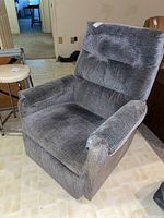 Front angle view of grey corduroy rocking recliner showing seat, back and armrests
