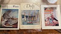 Photo showing three folders and prints including Watts and Dufy collections and additional Vanessa Bell print.