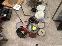 Overview photo of drums and triangles arranged on carpet showing multiple percussion instruments with some damaged drumheads