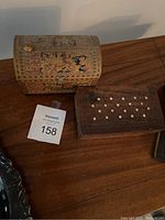 Two small wooden boxes side by side on wooden surface, showing top and side details