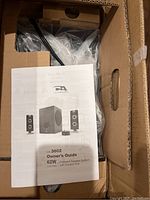 Original box with owner's guide and components visible inside.