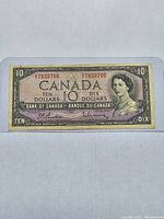 Front side of the 1954 Canadian $10 banknote showing Queen Elizabeth II portrait and serial number SV7839706 in red.