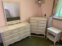 All three pieces: large dresser with mirror, tall dresser, nightstand arranged in room.