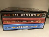 Three hardcover books stacked in a slipcase seen from the spine side.